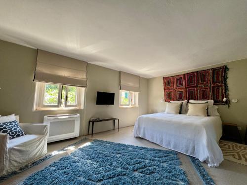 a bedroom with a large bed and a rug at La Casetta in riva al mare in Quercianella