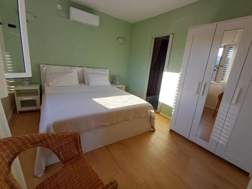 a bedroom with a bed and a door to a hallway at House Dinko in Vinišće