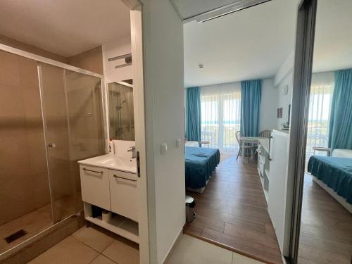 a bathroom with a shower and a sink in a room at Studio Cris Sea View in Blaxy Residence in Douăzeci şi Trei August