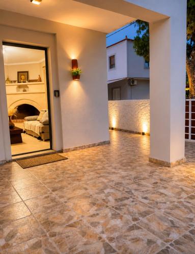 a room with a stone floor and a bedroom at Pipitsa's House-Votsalakia Beach in Votsalákia