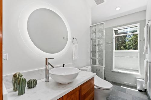 a bathroom with a bowl sink and a mirror at Redwood Oasis - Luxe Santa Cruz Cabin w/ Hot Tub in Ben Lomond