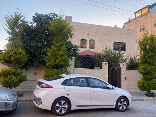a white car parked in front of a house at alrayan in King Faisal Airbase