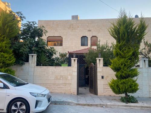 a white car parked in front of a house at alrayan in King Faisal Airbase