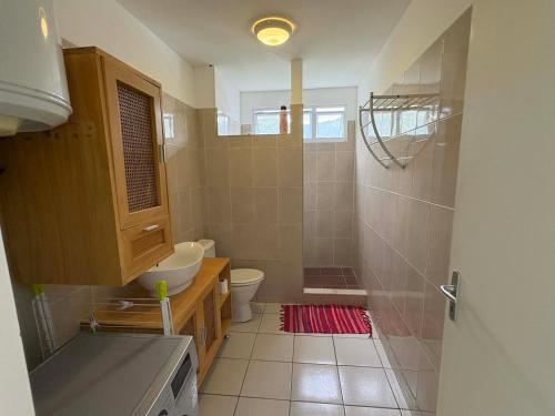a bathroom with a toilet and a sink at Lodge Tahiti in Papeete