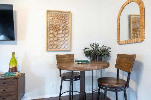 a table with two chairs and a mirror on a wall at Couples Condo Retreat Overlooking Golf Course in Branson West