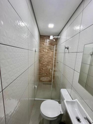 a bathroom with a shower and a toilet and a sink at New Comercial Palace Hotel in São Paulo