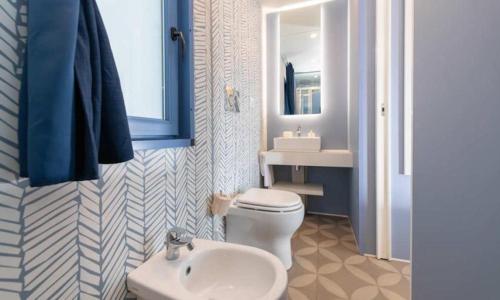 a bathroom with a white toilet and a sink at Camping Pineta - Nikoli Tour in Cesenatico
