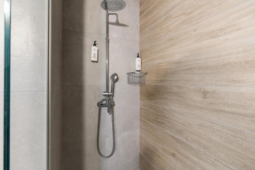 a shower with a shower head in a bathroom at WAKE UP BY THE SEA BEACHFRONT FLATS - Protaras in Protaras