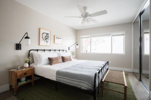 a bedroom with a bed and a ceiling fan at Seashore Suites by AvantStay in San Diego