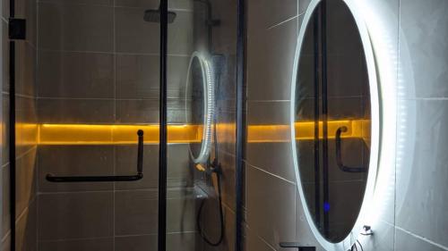 a mirror on the side of a shower in a bathroom at 4 Bedroom duplex in Orchid in Lekki