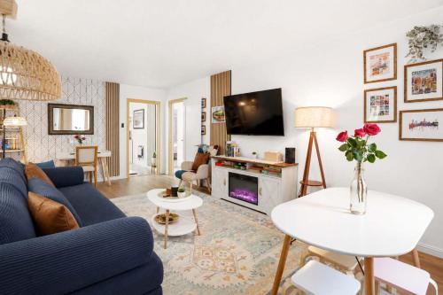 a living room with a blue couch and a tv at Ocean glimpse from the patio in Pacifica