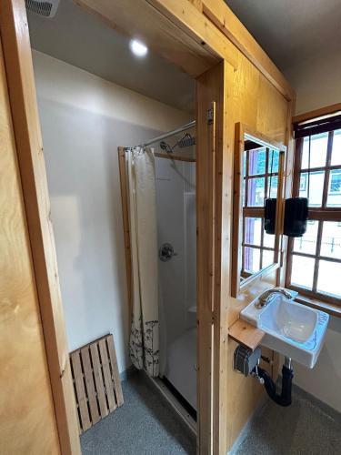 a bathroom with a sink and a mirror at The Bunkhouse in Dawson City