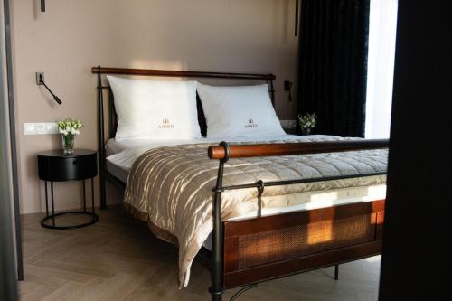 a bedroom with a bed with white pillows and a window at Amber Sun Towers 11th Floor in Świnoujście