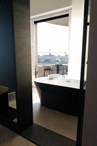 a bath tub in a room with a window at Amber Sun Towers 11th Floor in Świnoujście