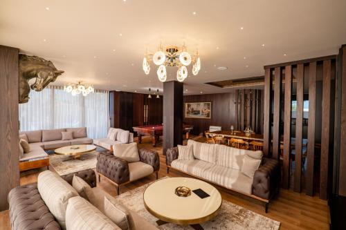 a living room with couches and a pool table at HH Point Luxury Villas in Durrës