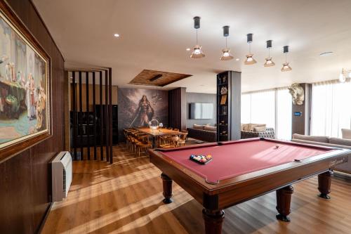 a living room with a pool table in it at HH Point Luxury Villas in Durrës