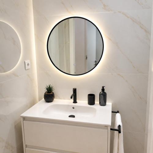 a bathroom with a white sink and a mirror at Alameda Apartments 2 in Trofa