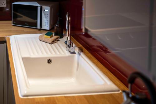 a kitchen sink with a sponge and a faucet at The Bothy in Dundee