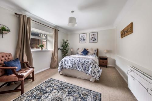 a bedroom with a bed and a chair and a window at The Bothy in Dundee