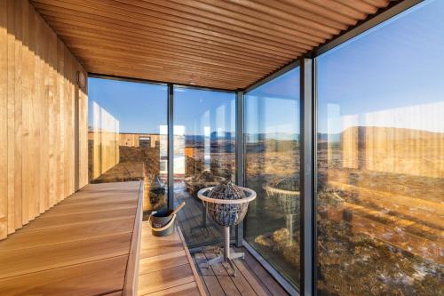 a glass house with a view at ÖÖD Hekla Horizon - Mirror Houses in Hella