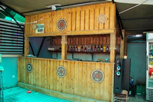 a wooden bar with bottles on the wall at MF Supreme Hotels and suites in Ikorodu