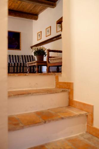 a stairway with a bench and a table at Riserva Privata San Settimio in Arcevia