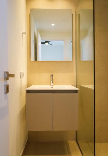 a bathroom with a sink and a mirror and a shower at Villa Artemis 2 - Etheras Properties in Kythira