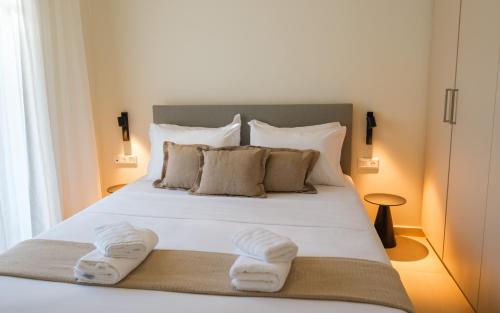 a bedroom with a bed with towels on it at Villa Artemis 2 - Etheras Properties in Kythira