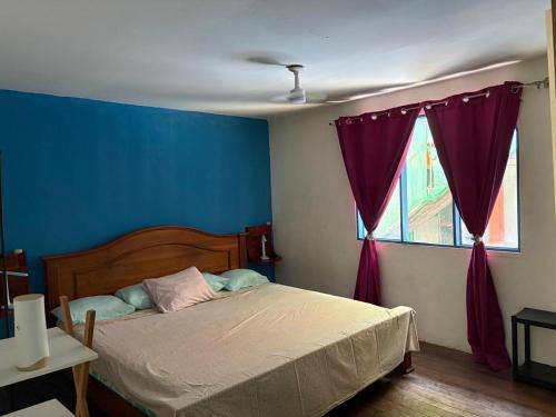 a bedroom with a bed and a window at Casa Azul by Silvia Sàmara in Nicoya