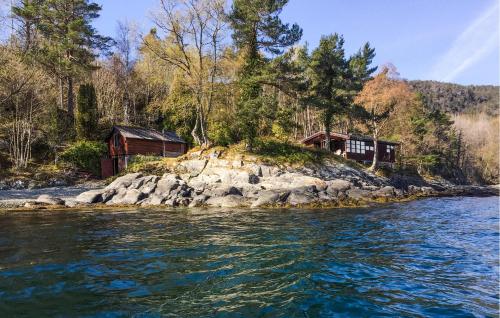 a house on a small island in the water at 2 Bedroom Nice Home In Hatlestrand in Hatlestrand