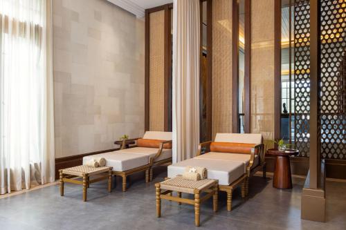 a waiting room at a hotel with chairs and tables at Plataran Borobudur in Borobudur