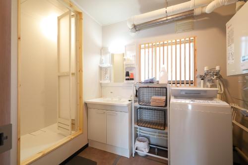 a kitchen with a dishwasher and a washer at plus81 OTARU Entire House 9min Walk from Minami Otaru Station in Otaru