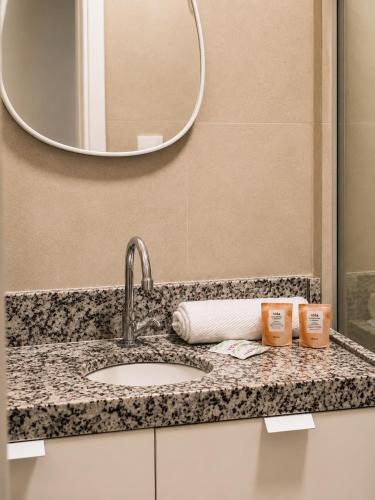 a bathroom counter with a sink and a mirror at Life Center in Caruaru