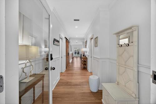 a hallway with white walls and a hallway with a door at OG14: 14 Ocean Green in Kiawah Island