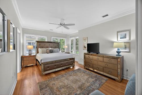 a bedroom with a bed and a flat screen tv at OG14: 14 Ocean Green in Kiawah Island