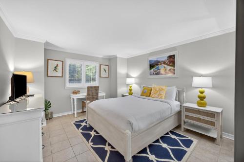 a bedroom with a bed and a desk and a tv at SS3512: 3512 Seascape in Kiawah Island