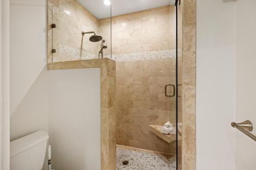 a bathroom with a shower with a glass door at SS3510: 3510 Seascape in Kiawah Island