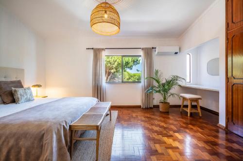 a bedroom with a large bed and a potted plant at Vilamoura Escape with Private Pool in Vilamoura