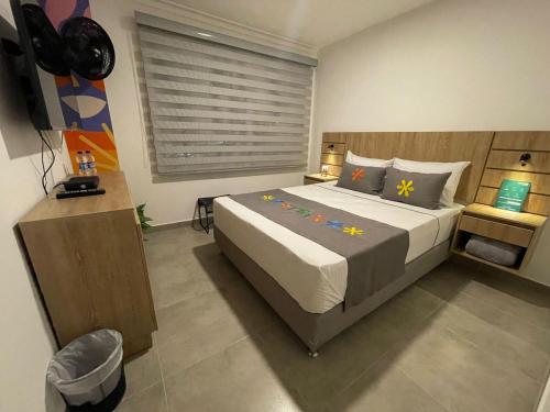 a bedroom with a large bed in a room at Hotel Medallo City in Medellín