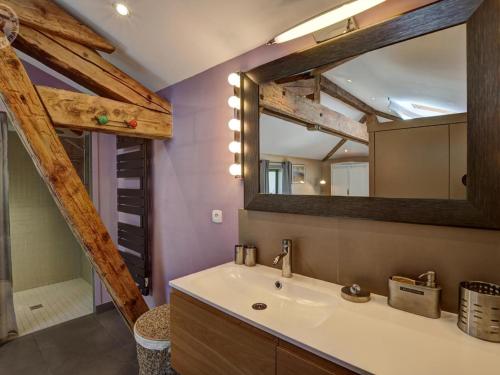 a bathroom with a sink and a mirror at Gîte au cœur d'un village médiéval, charme et confort moderne - FR-1-496-125 in Chagnon