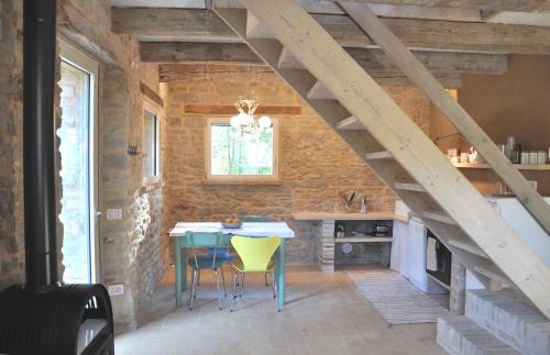 a kitchen with a table and chairs in a room at Borgo Farneto in Montecarotto