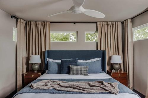 a bedroom with a blue bed with a blanket on it at Expansive Luxury Escape with Private Pool in Austin