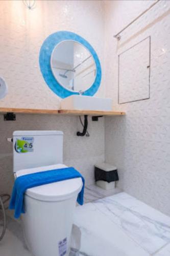 a bathroom with a white toilet and a mirror at Castaway's hua hin in Hua Hin