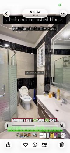 a bathroom with a toilet and a sink and a mirror at Behria town phase 8 in Rawalpindi