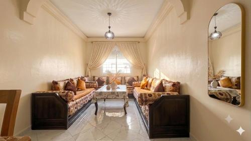 a living room with a couch and a table at Cozy Apartment Near Rabat & Beach in Temara