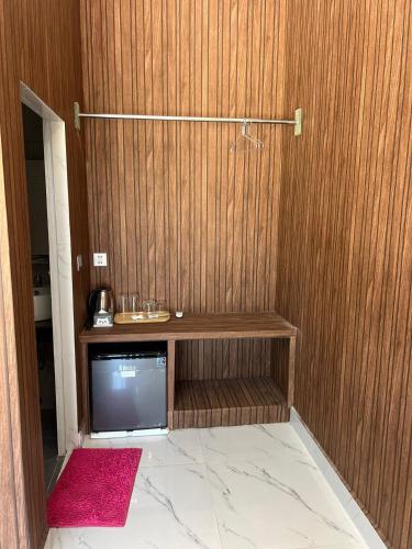 a tv in a room with a wooden wall at MN Koh Kong Resort in Koh Kong