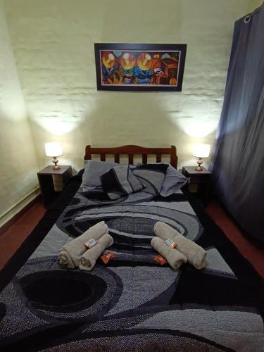 a bedroom with a bed with towels on it at Cielo Serrano VCP in Villa Carlos Paz