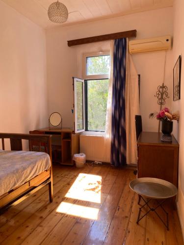 a bedroom with a bed and a window at Mytilini Townhouse in Mytilene