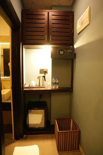 a bathroom with a counter with a sink and a mirror at Hotel Sangiliyan in Jaffna