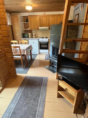 a kitchen with a table and a stove top oven at Arola 2 in Syöte